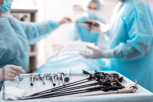 Close up of sterile table with laparoscopic tools, scissors, trocars, cannulas and clip applicator photo