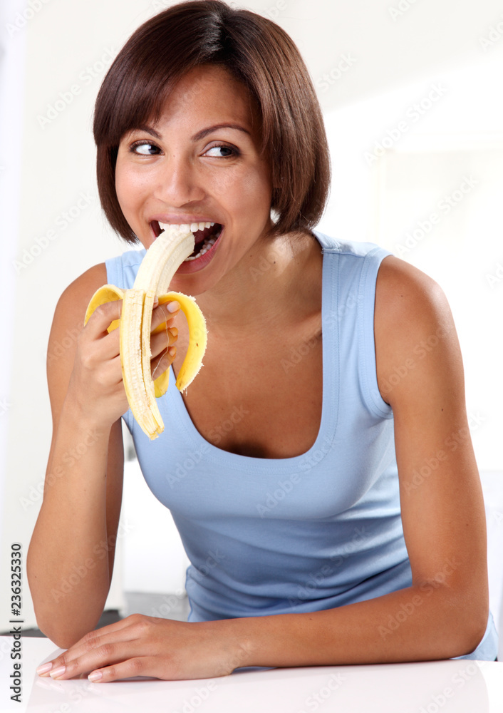 WOMAN EATING A BANANA WOMAN EATING A BANANA