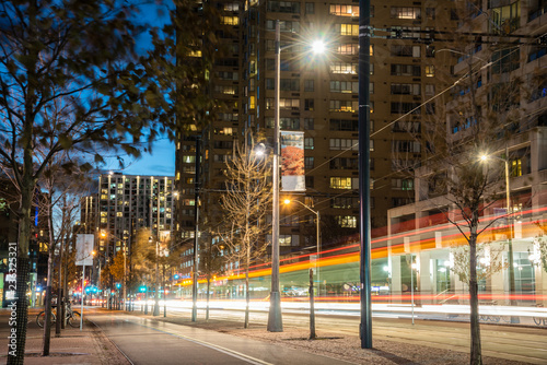 Photography Empty Cycle Lane Running alongside a Tramway at Night with Light Trails Letf by a passing Tram