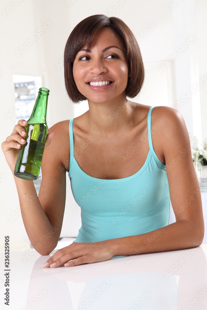 WOMAN DRINKING BEER FROM BOTTLE