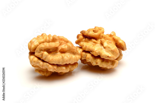 Two walnut kernels, close up macro, isolated on a white background.