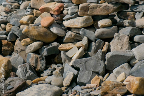 Wall of stones on the sea shore beach.