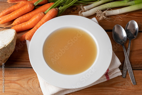 Chicken bone broth in a plate, top view