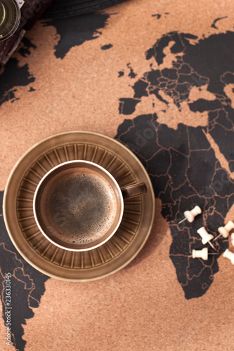Canvas Print A cup of aromatic coffee on the map and accessories for travel