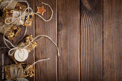 Homemade granola oatmeal energy bars, on wood desk wyth copy space for text