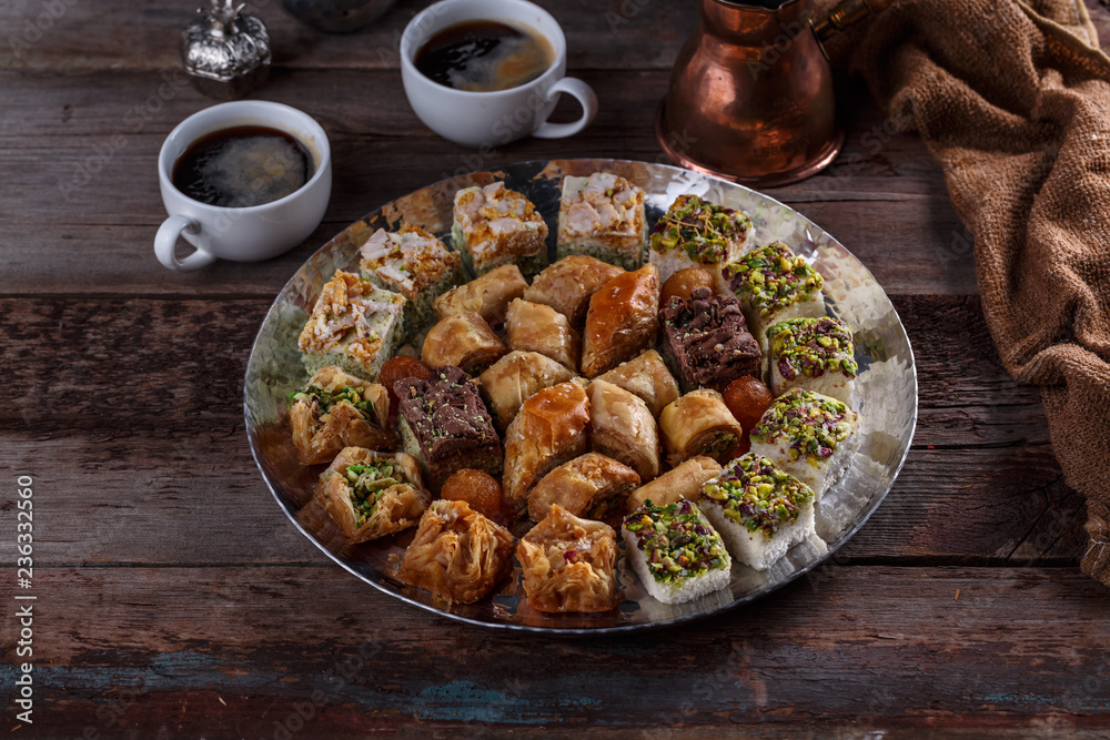 Oriental Baklava and delights on silver tray with coffee Oriental Baklava and delights on silver tray with coffee