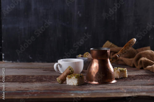 Traditional turkish coffee and turkish delight on dark wooden backgroundm copy space