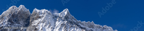 Panoramic landscape with a chain of mountain in a clean blue sky with snow in the italian winter © Daniel Carnielli