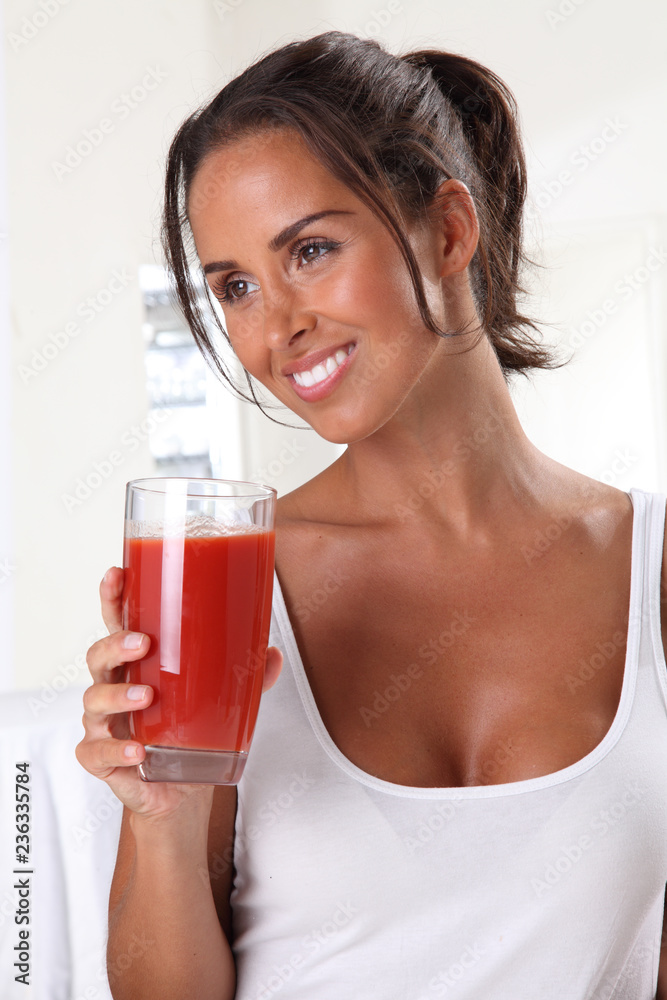 WOMAN DRINKING TOMATO JUICE
