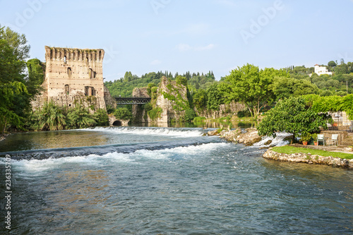 Visconti bridge of Valeggio sul Mincio at Borghetto with reflections in Mincio river, Italy