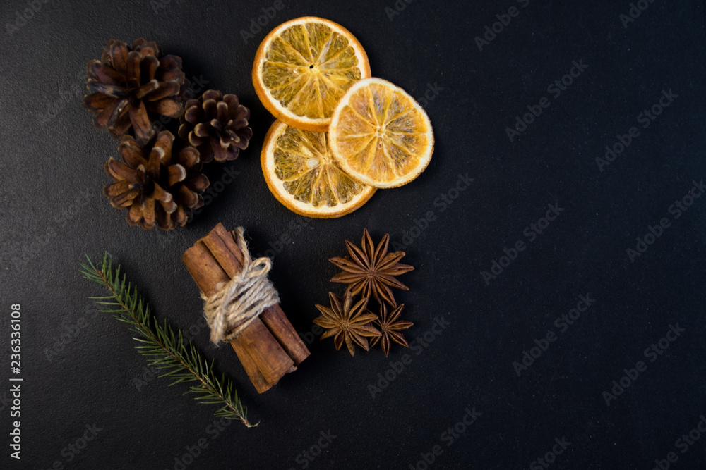 Christmas Tree Pine Branches with dry oranges. cinnamon, anise, pine on a dark background.