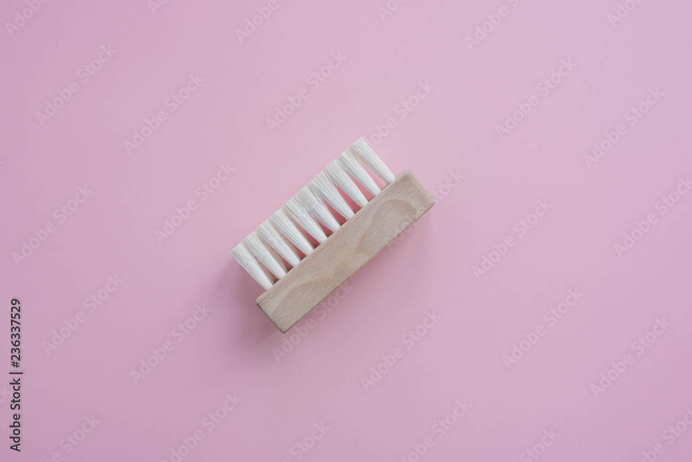 A stylish wooden brush for cleaning sneakers or any other footwear. Free space for text, background for designers. Isolated element on a light background. A stylish wooden brush for cleaning sneakers or any other footwear. Free space for text, background for designers. Isolated element on a light background.