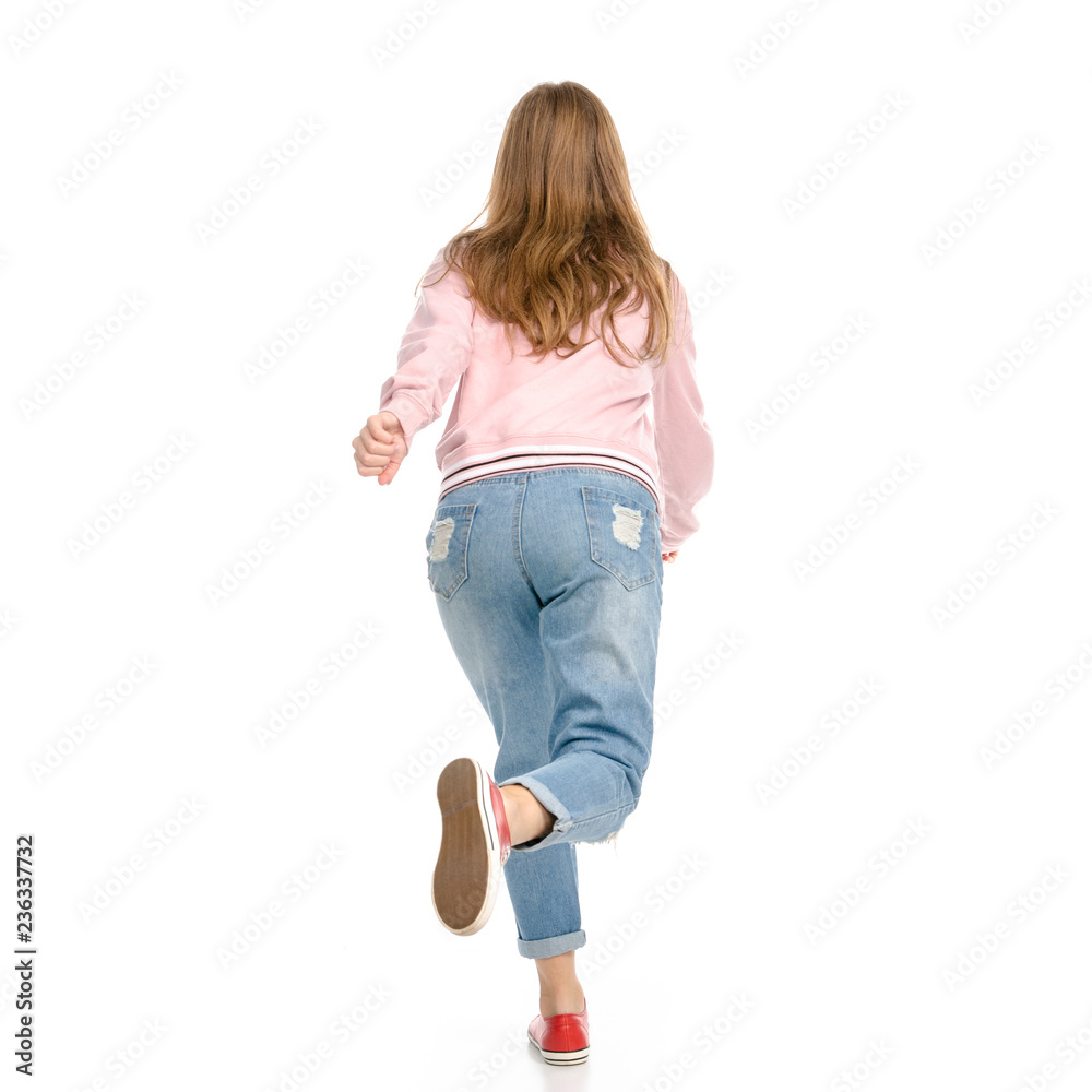 Beautiful woman in jeans jumping happy goes runs on white background isolation back view Beautiful woman in jeans jumping happy goes runs on white background isolation back view