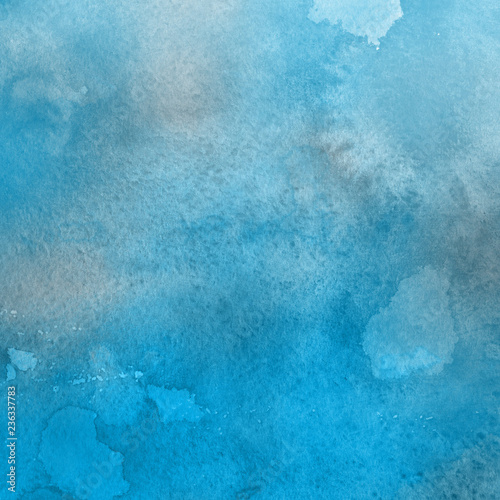 Blue watercolor winter texture with abstract washes and brush strokes on the white paper background.