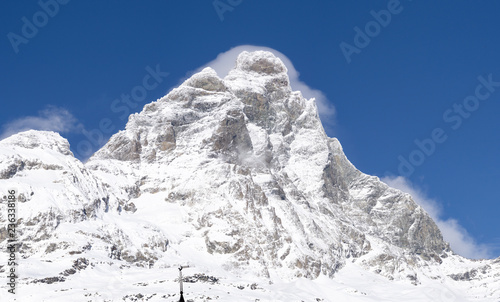 Motterhorn iluminated by the direct sun reflecting the white snow surrounded by the blue sky © Daniel Carnielli