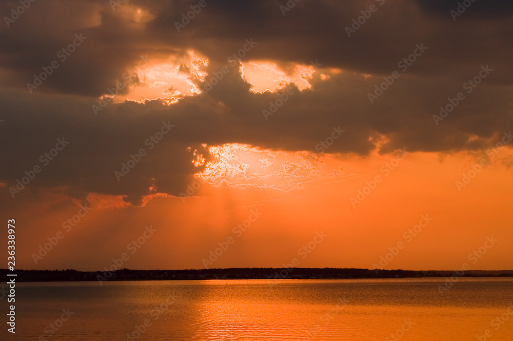 Fototapeta premium Clouds over the lake at sunset