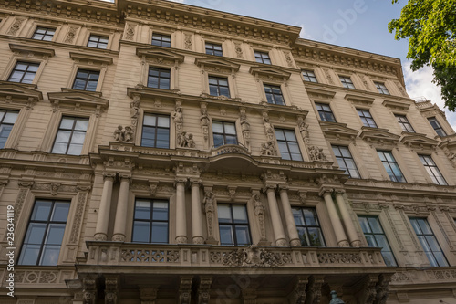 Facade of an old house in Vienna, Austria. Decorated wall with windows, balconies and stucco work.