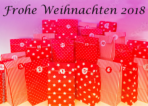 Door of an advent calendar with 24 parcels in red with in german Frohe Weihnachten 2018 in english Merry Chrstmas 2018