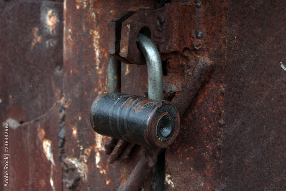 close up large metal rusted garage doors locked. close up large metal rusted garage doors locked.