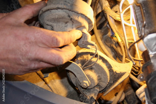 Fototapeta Naklejka Na Ścianę i Meble -  Men's rough hands hold the rusted electrical car horns - old vehicle repair