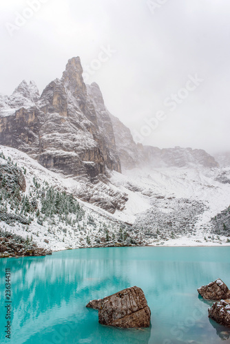 The mountain lake Lago di Sorapiss in Dolomite Alps. Italy, with amazing turquoise color of water. photo