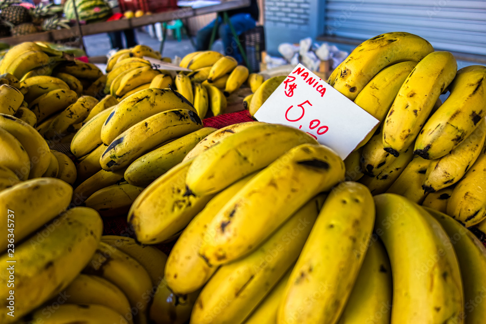 bananas nanica with the price announcement of R$ 5.00 per kilo at a free street fair in Brazil