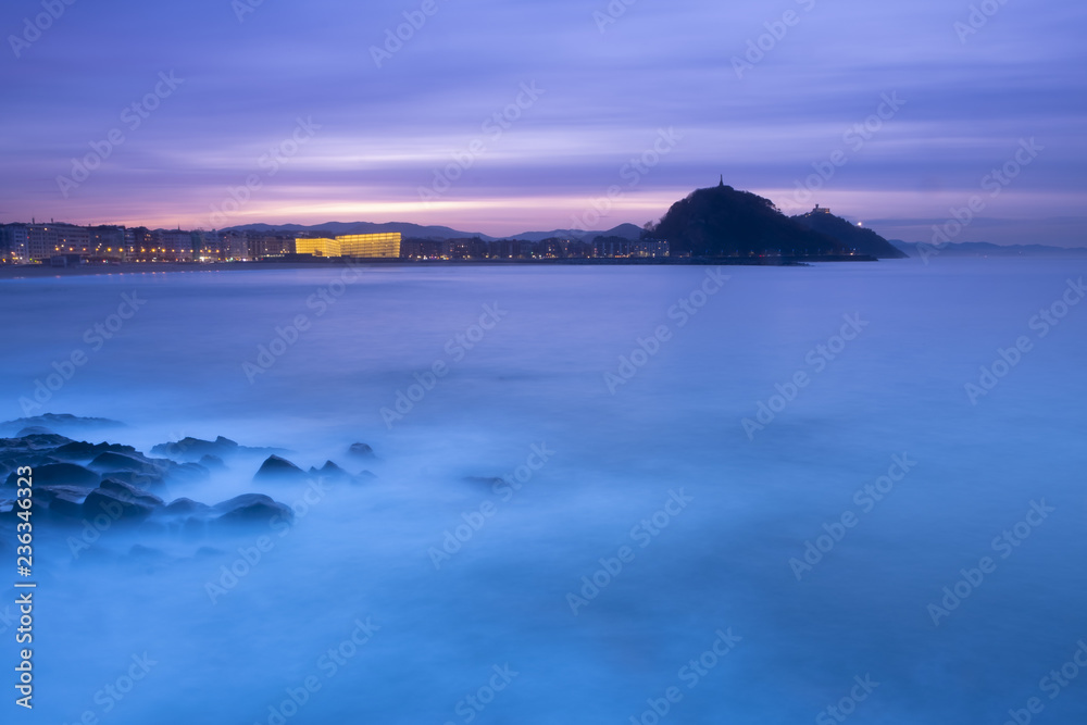 Sunset in the sea with Zurriola beach in the city of San Sebastian, Basque Country