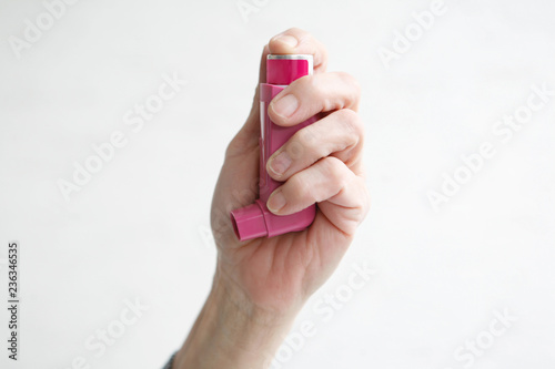 Woman holding Asthma Inhaler, Health. 