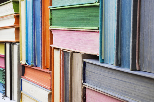 Many old books stacked in texture