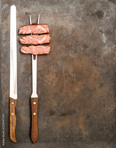 Grilled beef meat fork knife Food background