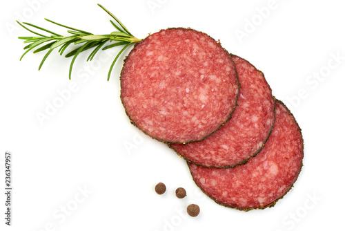 Salami sliced. Raw smoked sausage slices with herbs and spices, isolated on a white background. Top view.