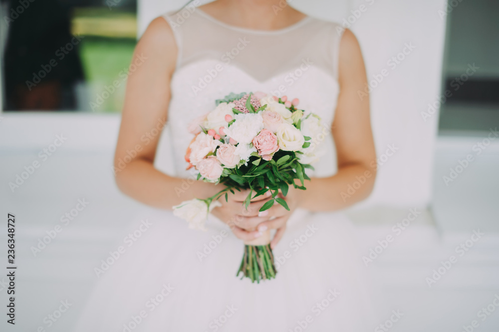 A beautiful bride is holding a wedding bouquet A beautiful bride is holding a wedding bouquet