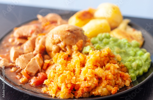An overloaded plate of chicken casserole, dumpling and vegetables
