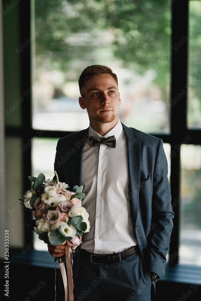 Stylish groom posing in a dark photo Studio. Morning newlyweds. Stylish groom posing in a dark photo Studio. Morning newlyweds.