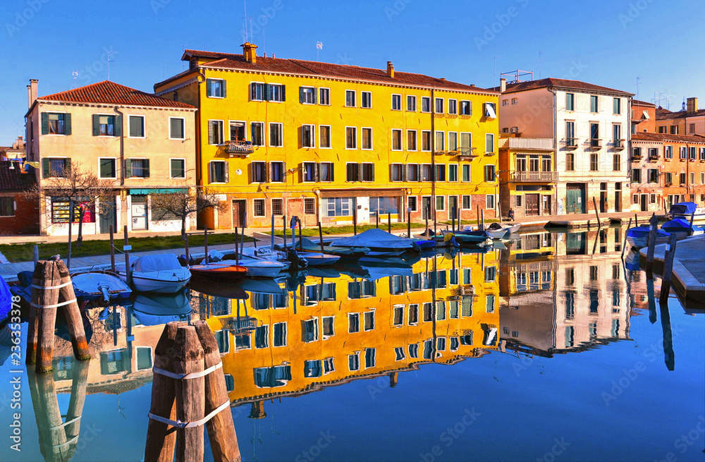 Venice colorful corners with canal, bridge, old buildings and architecture, people walking, boats and beautiful water reflections, Italy