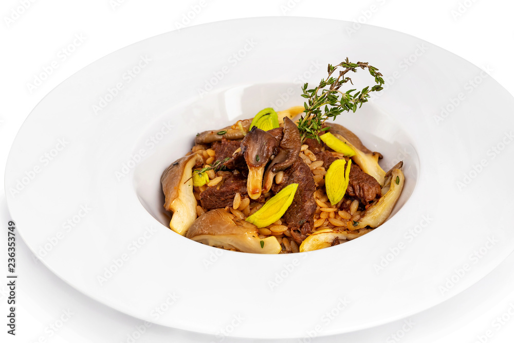 Plate of delicious beef steak with mushrooms and bulgur served with rosemary isolated at white background.