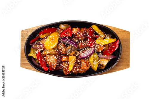 Pan of fried chicken with pineapple and grilled vegetables - pepper and onion served with sesame and teiyaki sauce at wooden board isolated at white background.