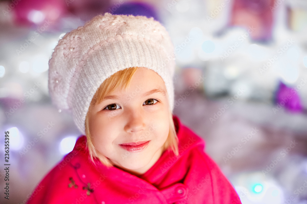 Portrait of little blonde smiling girl with white beret, red boots, pink cloak. Christmas and New Year theme Portrait of little blonde smiling girl with white beret, red boots, pink cloak. Christmas and New Year theme