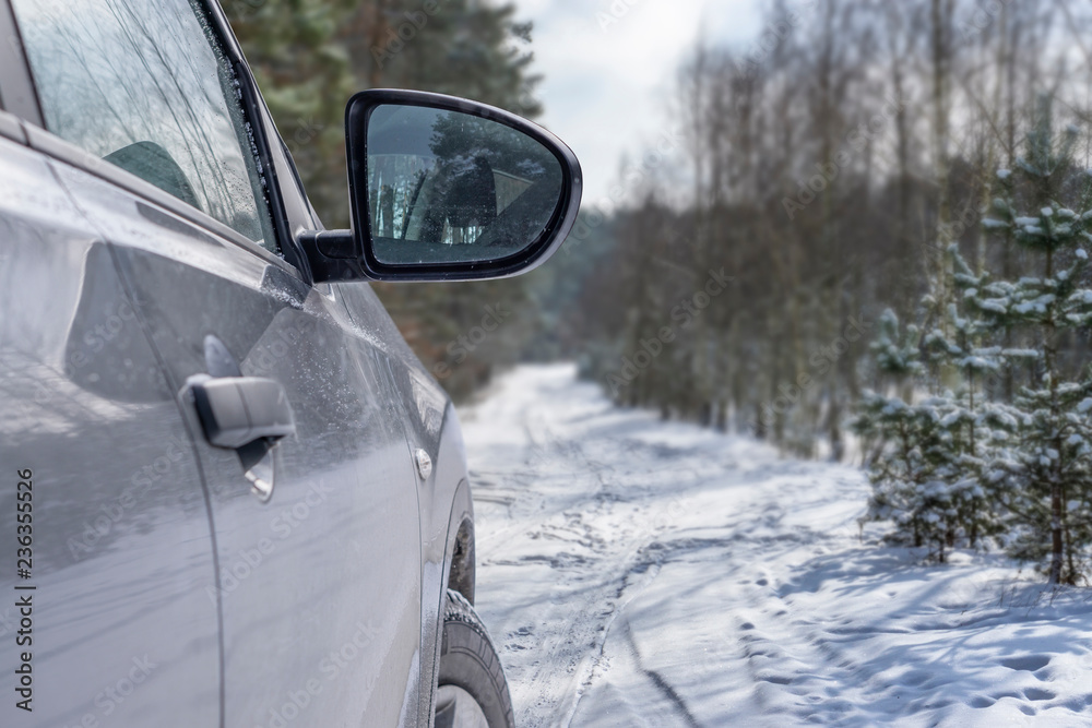 Obraz premium Car vehicle at snowy road in forest. Winter off road trip.