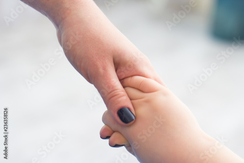 mom holding baby's hand