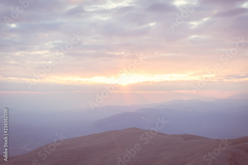 Sunset view from top of a mountain. View from Mount Nemrut, Turkey during golden hour.  © Elif