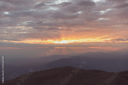 Sunset view from top of a mountain. View from Mount Nemrut  Turkey during golden hour. 