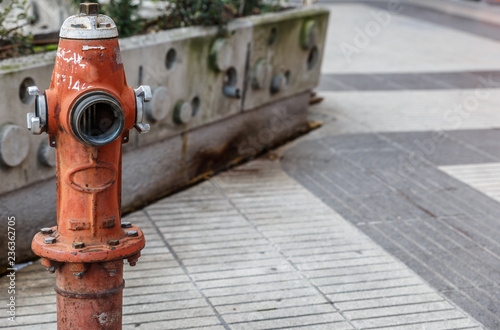 Water pump located on a street in a city, ready to be used by firefighters