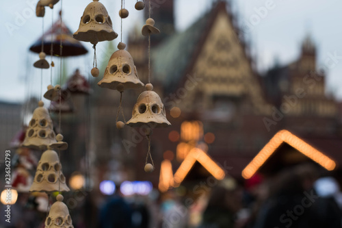 Handmade ceramic bells on the Christmas city market with blur background