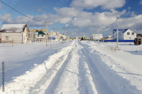 Snowy road, sunny winter day