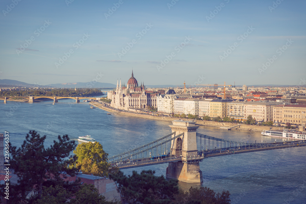 A postcard view of the Széchenyi Chain Bridge and the Hungarian Parliament Building. View from the top of the Buda Castle. 