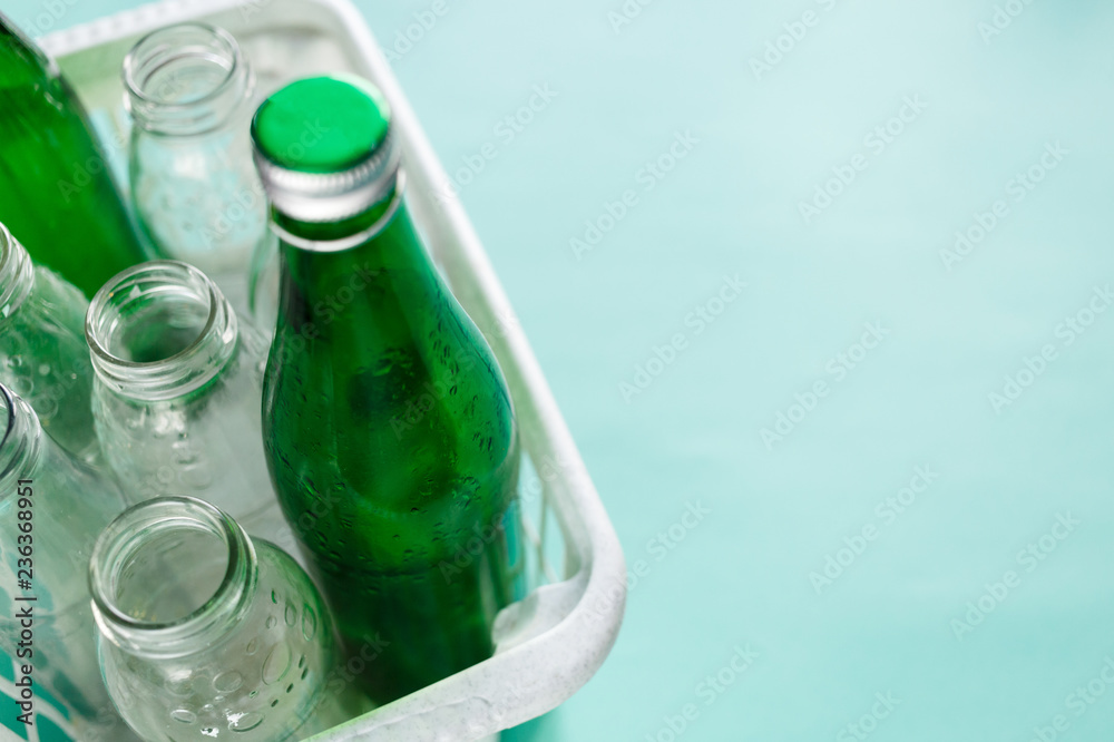 different wastes ready for recycling in white basket. Plastic bottles, glass, egg tray. Social responsibility, ecology care, recycling at home concept different wastes ready for recycling in white basket. Plastic bottles, glass, egg tray. Social responsibility, ecology care, recycling at home concept