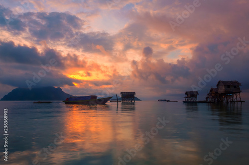 A cloudy sunrise at the sea gypsy village in Maiga Mabul Sipadan island, Semporna, Sabah, Malaysia.