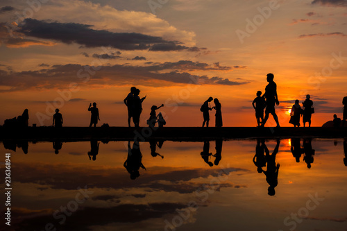 Silhouette of people visiting the Tanjung Aru beach during sunset located in Kota Kinabalu, Sabah, Malaysia.