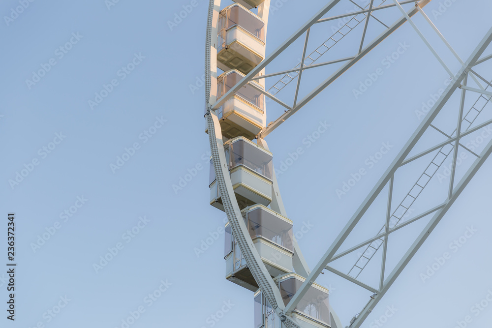 Low angle view of a ferris wheel with blue sky background 